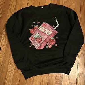 Adorable anime style graphics on black sweater